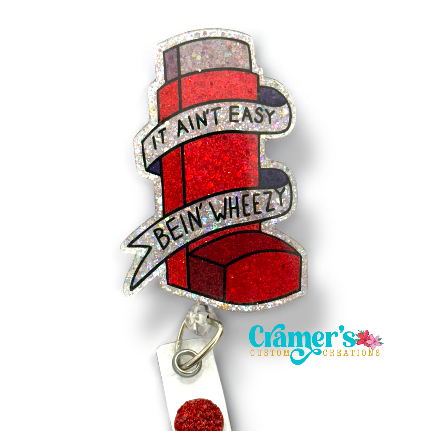 Red glitter inhaler badge reel that says it aint easy being wheezy