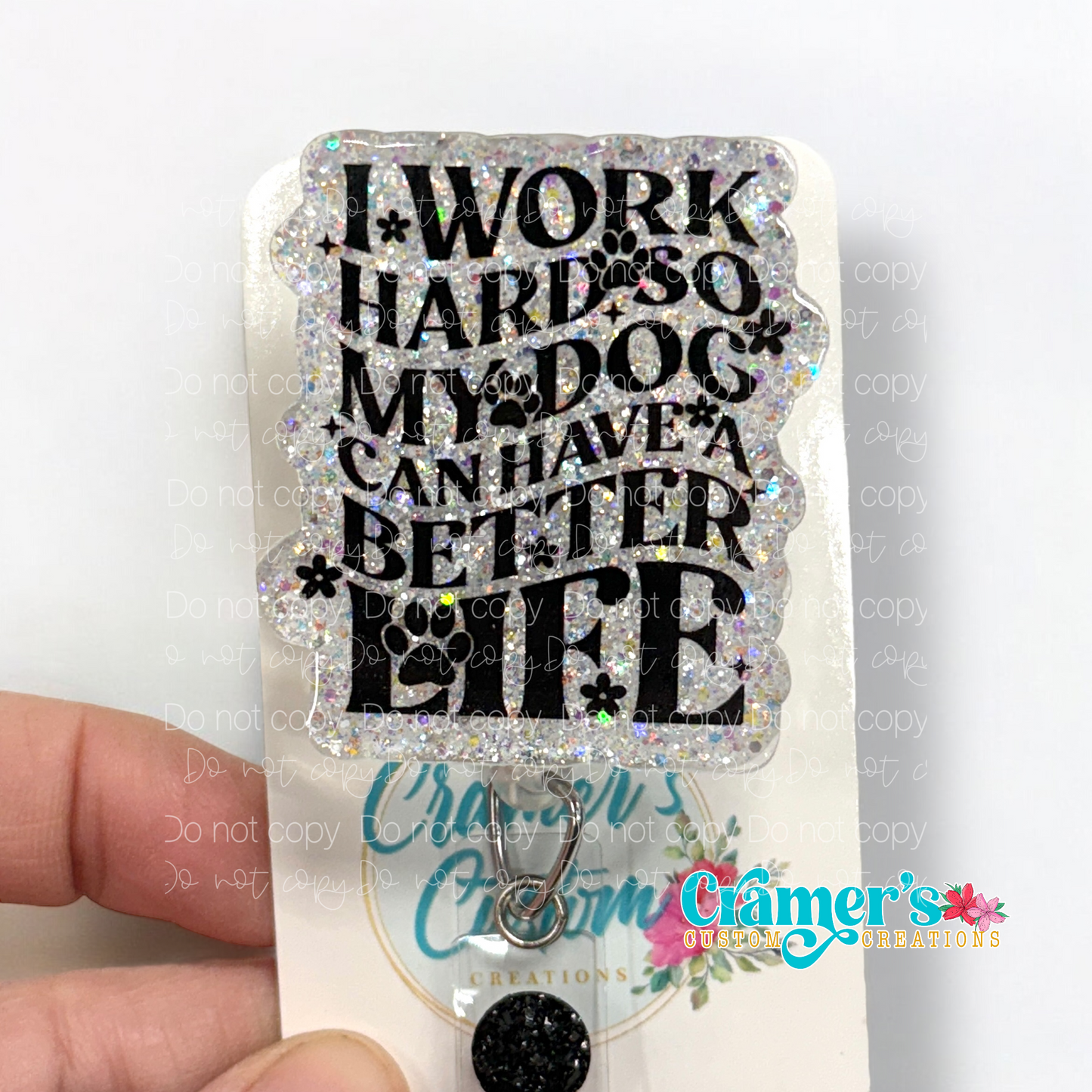 badge reel glitter white with black writing that says I work hard so my dog can have a better life