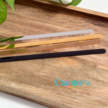 Set of four metal bangle bracelet blanks on a wooden surface with 'Cramer's Custom Creations' logo.