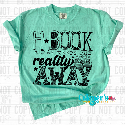 a green tshirt in a flat lay with the words a book a day keeps the reality away