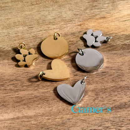 mulitiple charms in silver and gold on a wood backgrounf