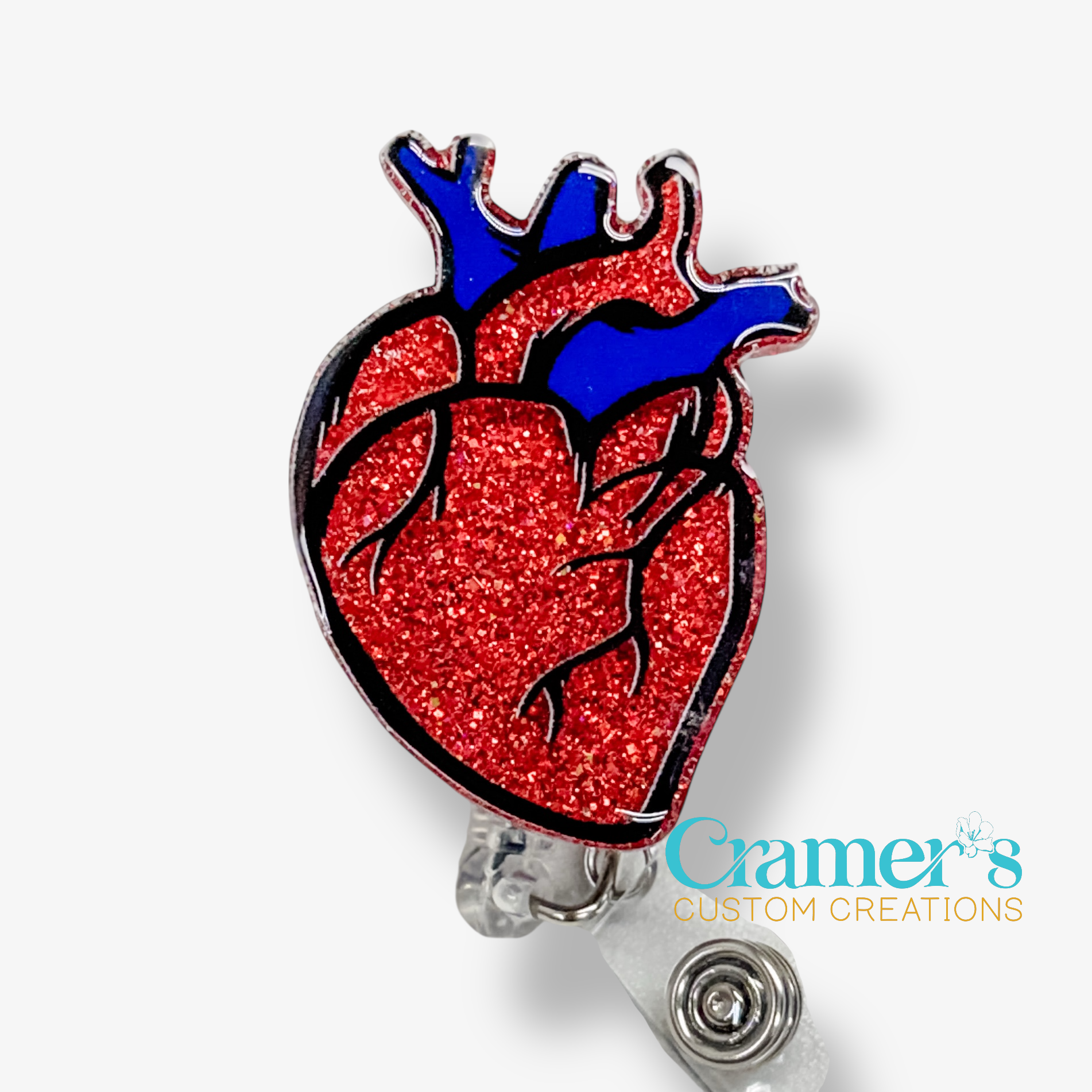 Heart-shaped badge holder with red glittery surface and blue top on a white background, featuring 'Cramer's Custom Creations' logo.