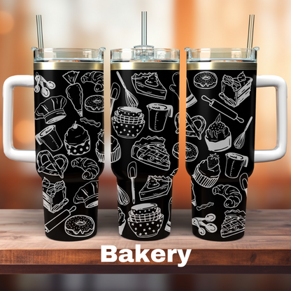 Three 40 oz black tumblers with laser engraved designs of baking utensils and food items, each adorned with the word 'BAKERY' at the bottom.