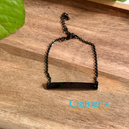Black bracelet on a wooden surface with 'Cramer's Custom Creations' branding.