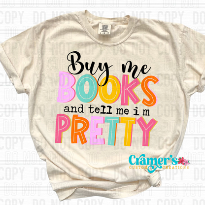 a cream color tshirt in a flat lay that says buy me books and tell me I'm pretty
