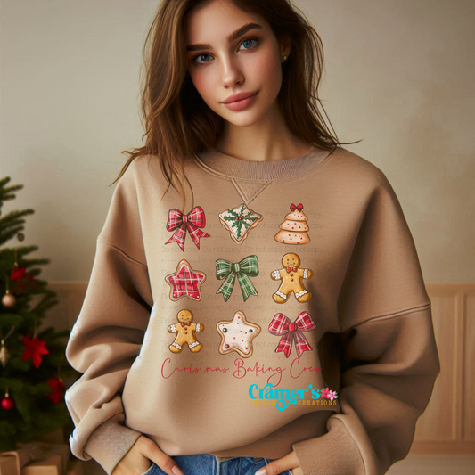 girl wearing a tan sweatshirt with a christmas grid of bows and cookies on it