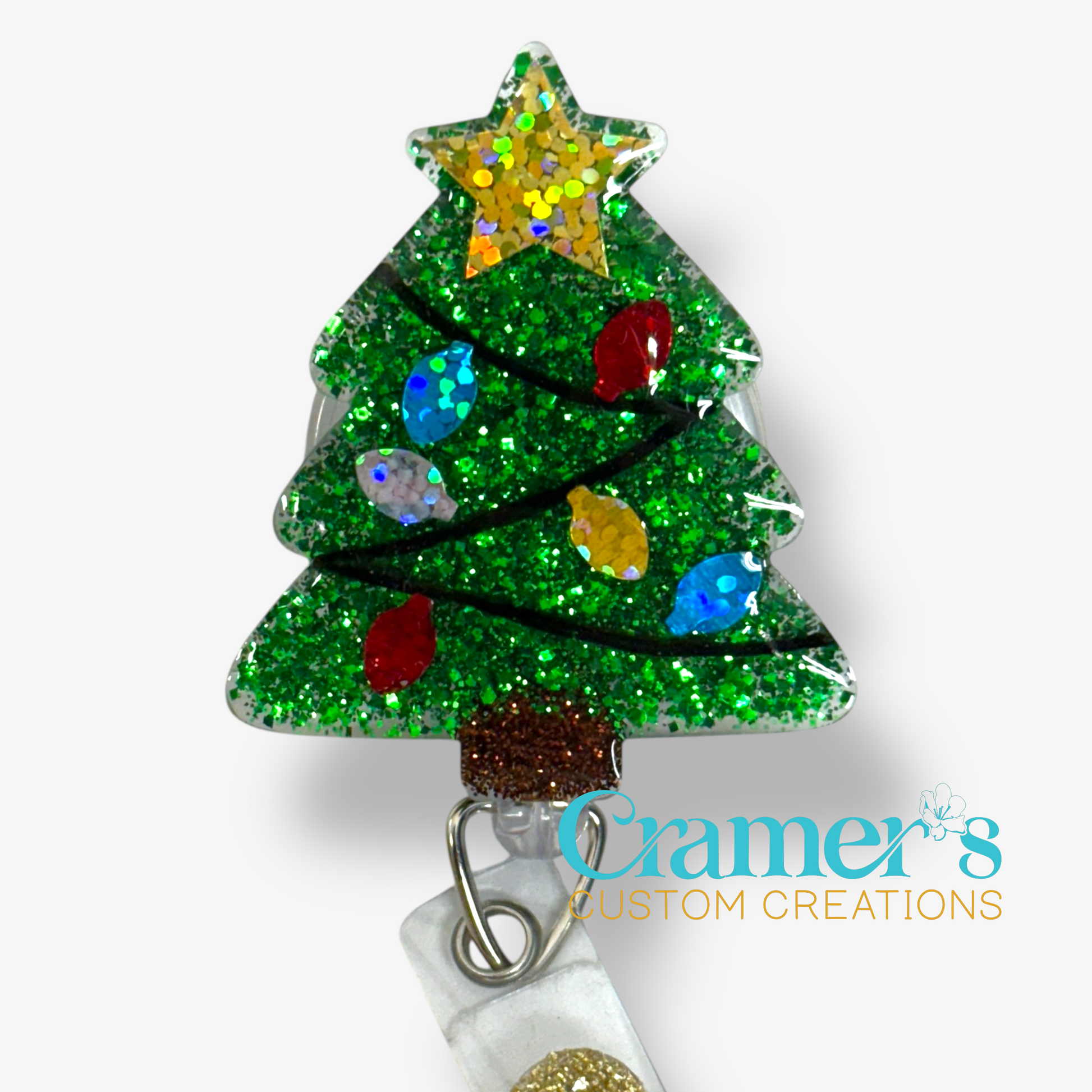 Glittery green christmas tree badge reel with colored bulbs and a gold star 