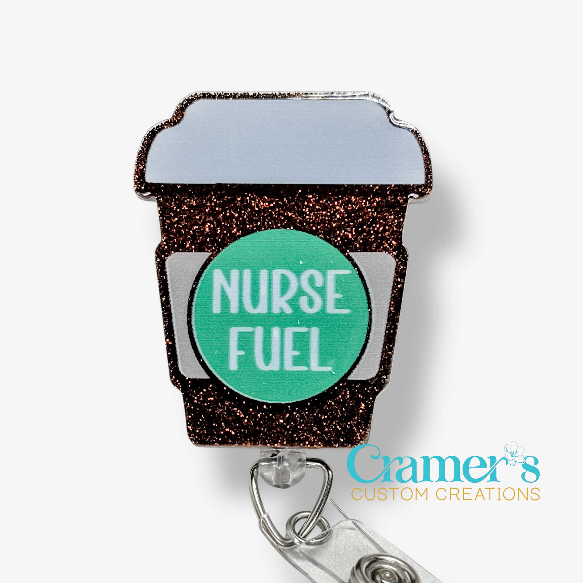Badge holder shaped like a coffee cup with 'Nurse Fuel' text on a white background, featuring the brand 'Gramer's Custom Creations'.