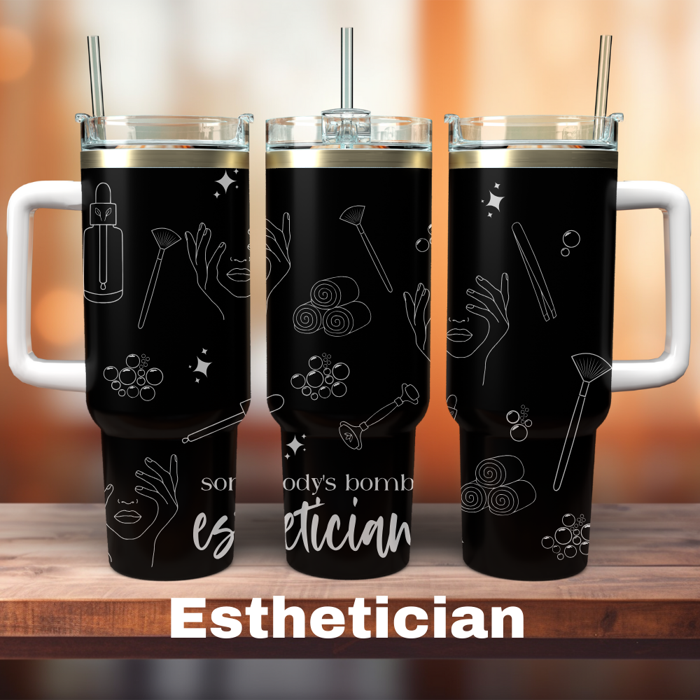 Two 40 oz black tumblers with white lids and esthetician-themed custom designs, one depicting tools and the other with text 'SOMEDAY'S BOOM'.