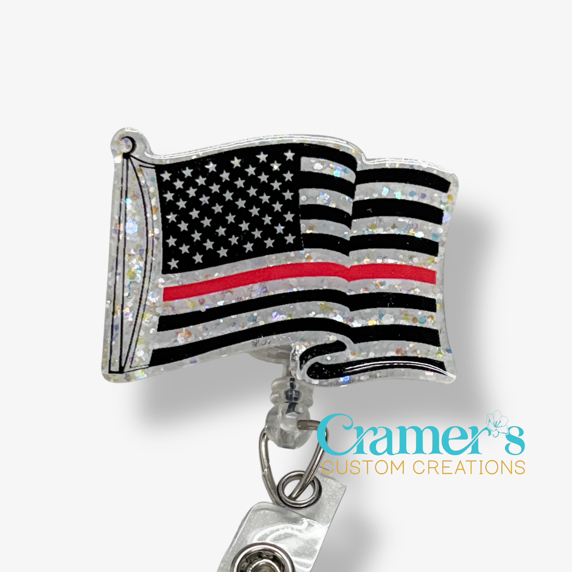 American flag badge reel with thin red line design on a white background, featuring 'Cramer's Custom Creations' logo.