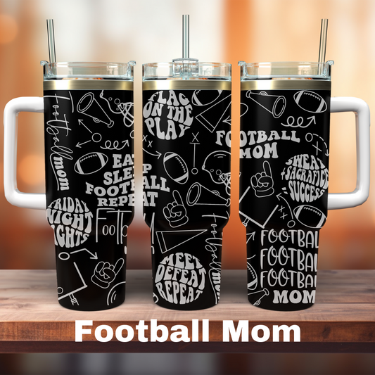 Three 40 oz black tumblers with white text and graphics related to football, positioned on a wooden surface. Each tumbler has a straw and a white lid.