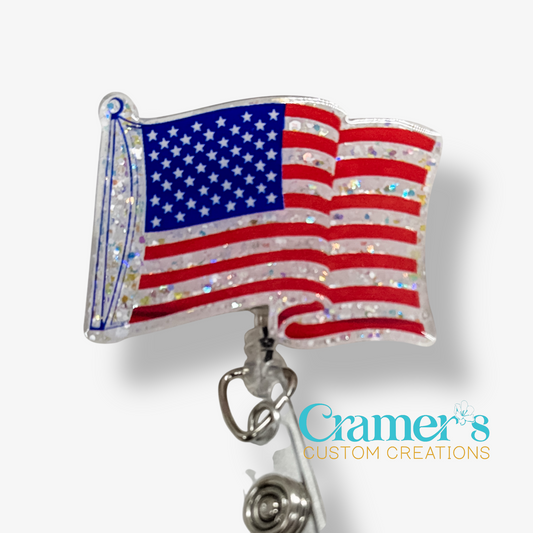 American flag badge reel with 'Cramer's Custom Creations' branding on a white background