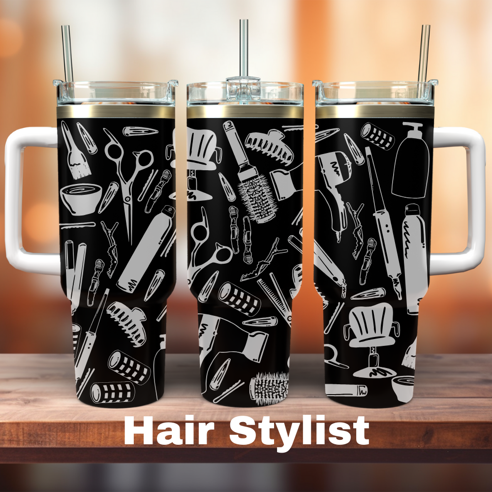 Two 40 oz tumblers with laser engraved hair styling tool designs, one with a straw and one without, on a wooden surface with the text 'HAIR STYLIST' at the bottom.
