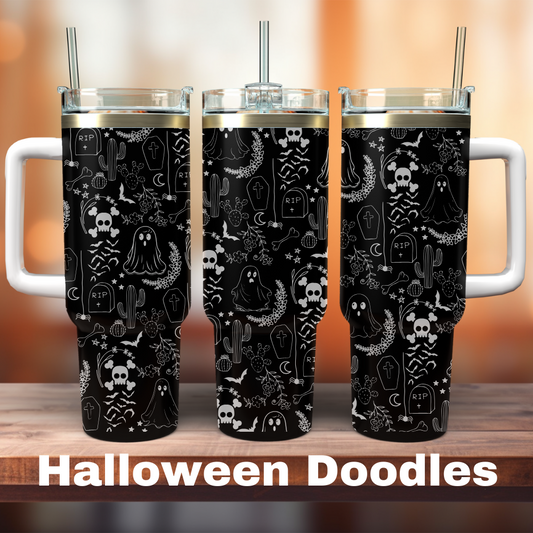 Three black 40 oz tumblers with white Halloween doodles, including ghosts, skulls, and pumpkins, displayed on a wooden surface.