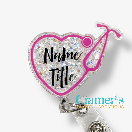 Heart-shaped badge holder with glittery design and 'Name Title' text, featuring Cramer's Custom Creations logo.