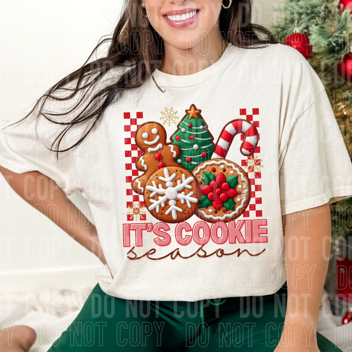 person wearing sweatshirt with christmas cookies in various shapes and it says its cookie season