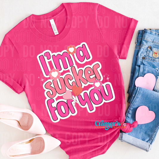 pink tshirt in a flat lay presentation with the words I'm a sucker for you
