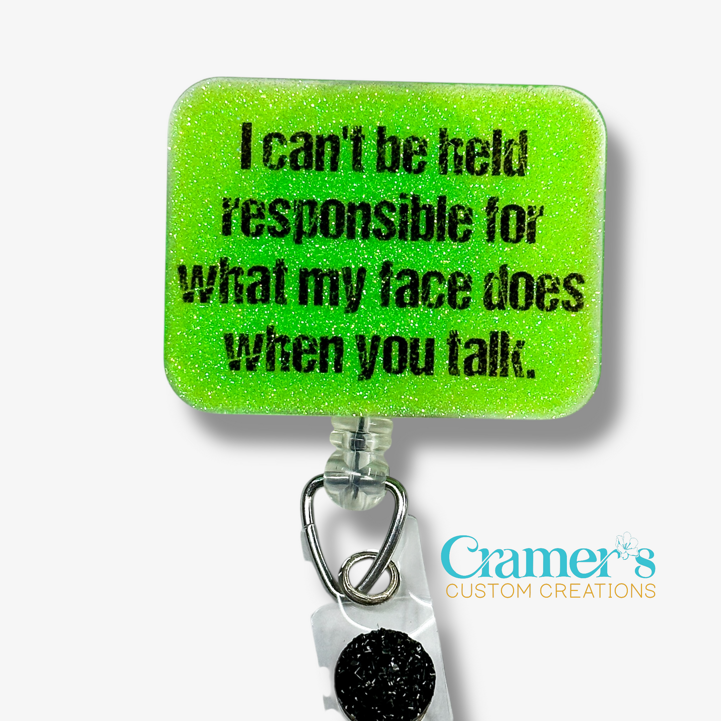 Green glittery badge holder with humorous text and Cramer's Custom Creations logo.
