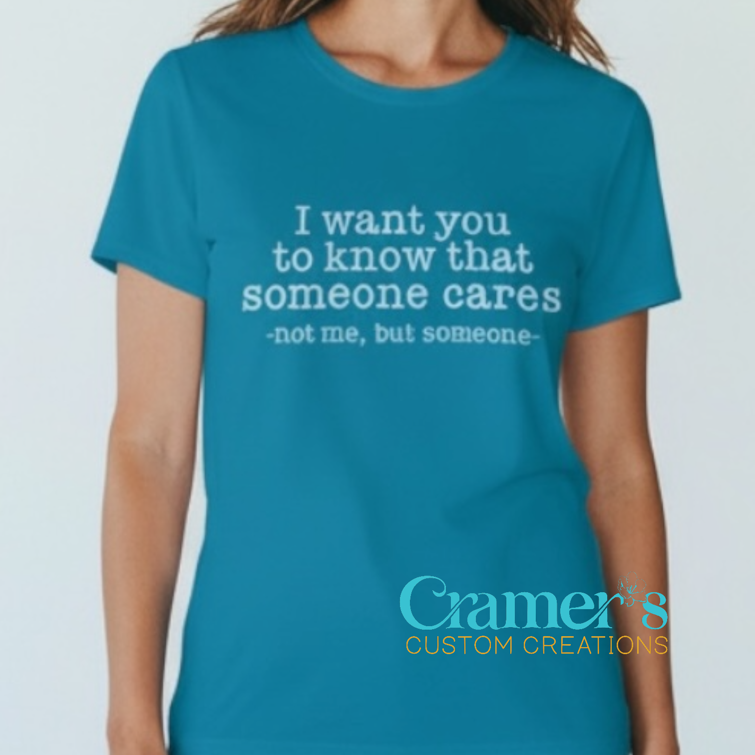 Person wearing a blue t-shirt with a motivational quote on a plain background