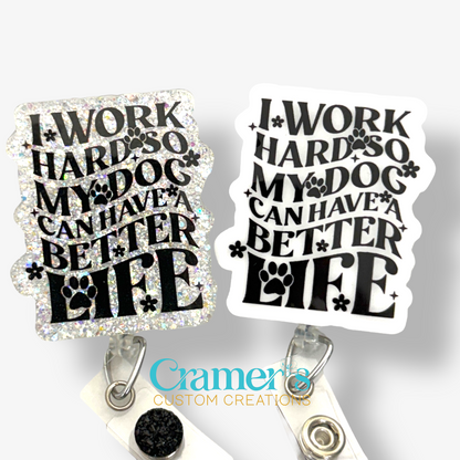 two badge reels one plain, one glitter both white with black writing that says I work hard so my dog can have a better life