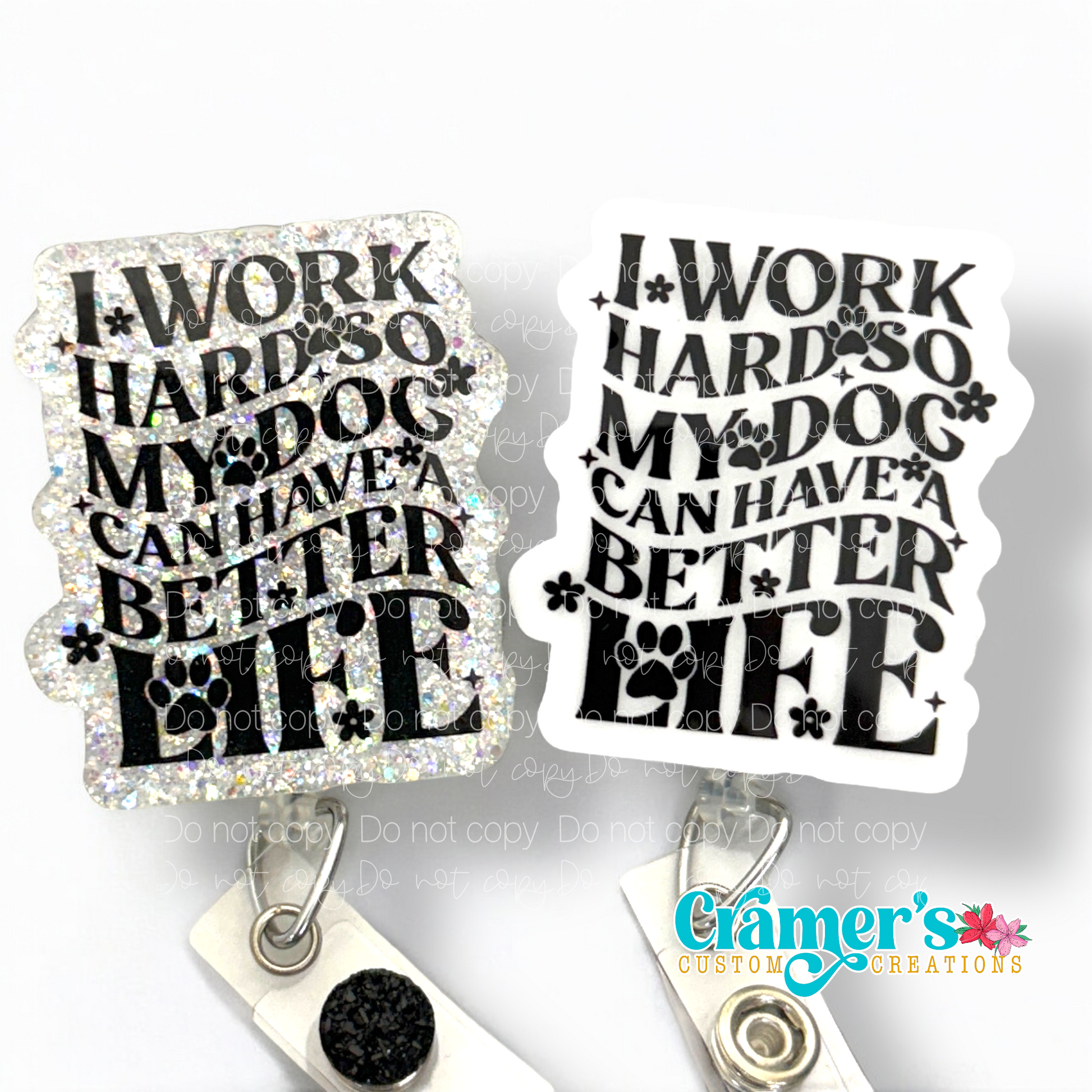 two badge reels one plain, one glitter both white with black writing that says I work hard so my dog can have a better life