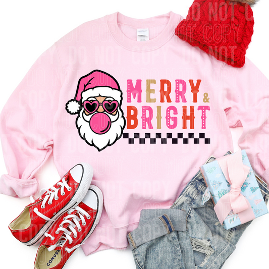 pink sweatshirt with the words merry and bright with santa blowing a bubble and a checked pattern across the bottom