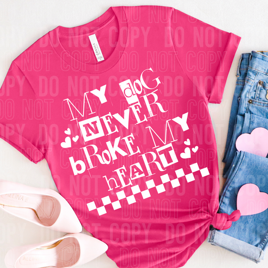 Hot pink shirt laying flat with the words my dog never broke my heart on it