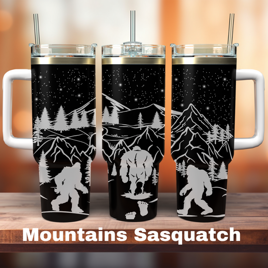 three 40oz black tumblers showing a mountain scene with sasquatch on it