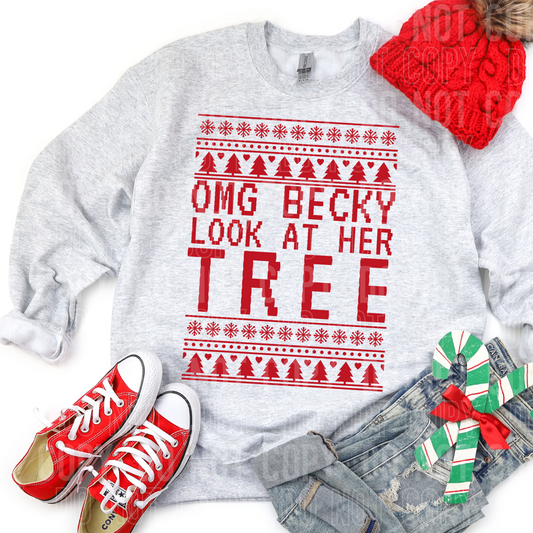 a sweatshirt with omg beck look at her tree on it in christmas sweater style with christmas style clothing and gifts as accents around the flat lay