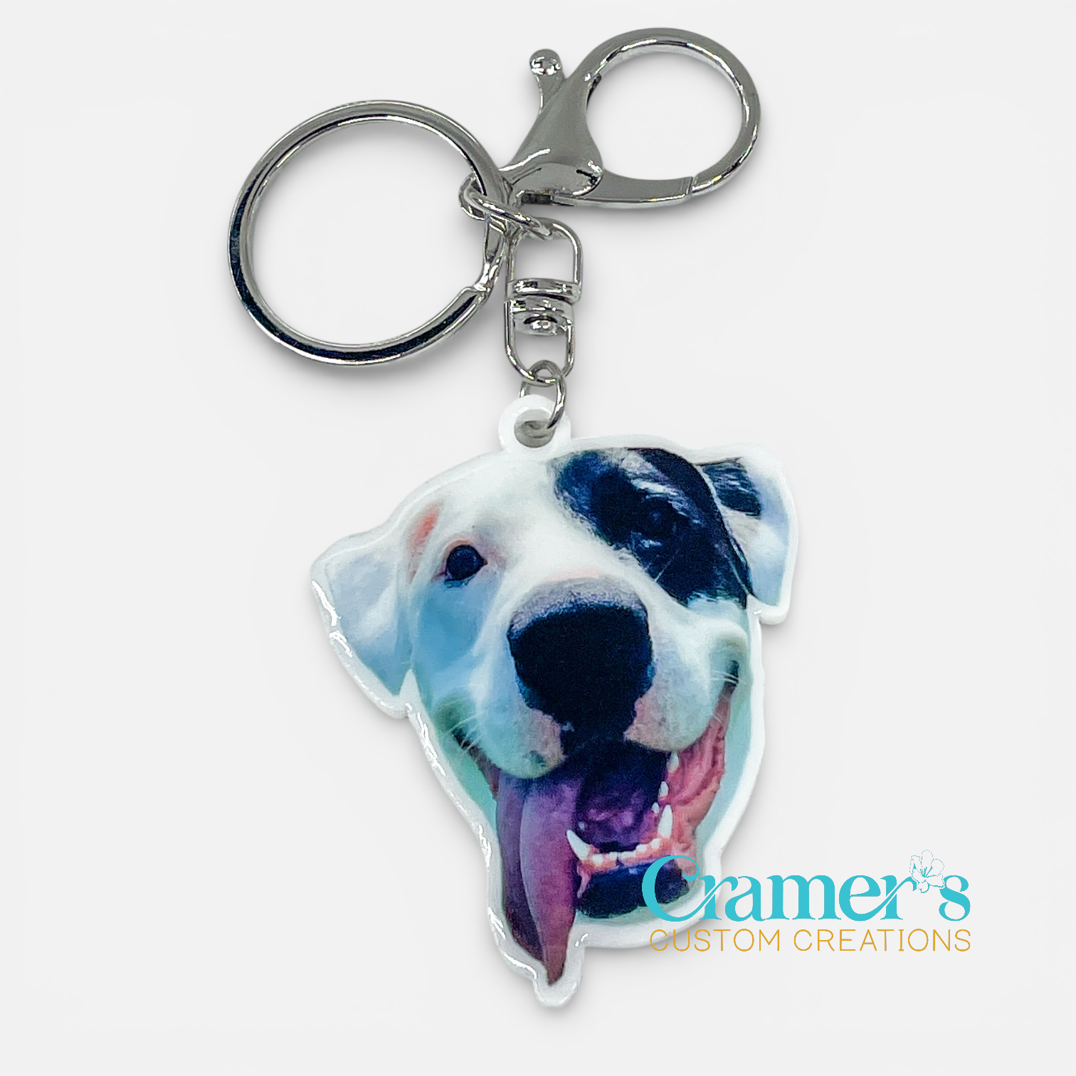 Dog-shaped keychain with a visible brand logo on a white background