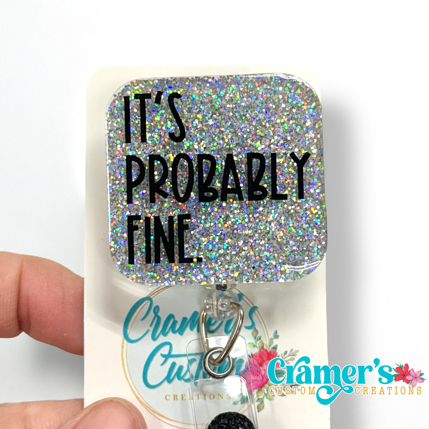 badge reel showing a silver glitter background with It's probably fine in black