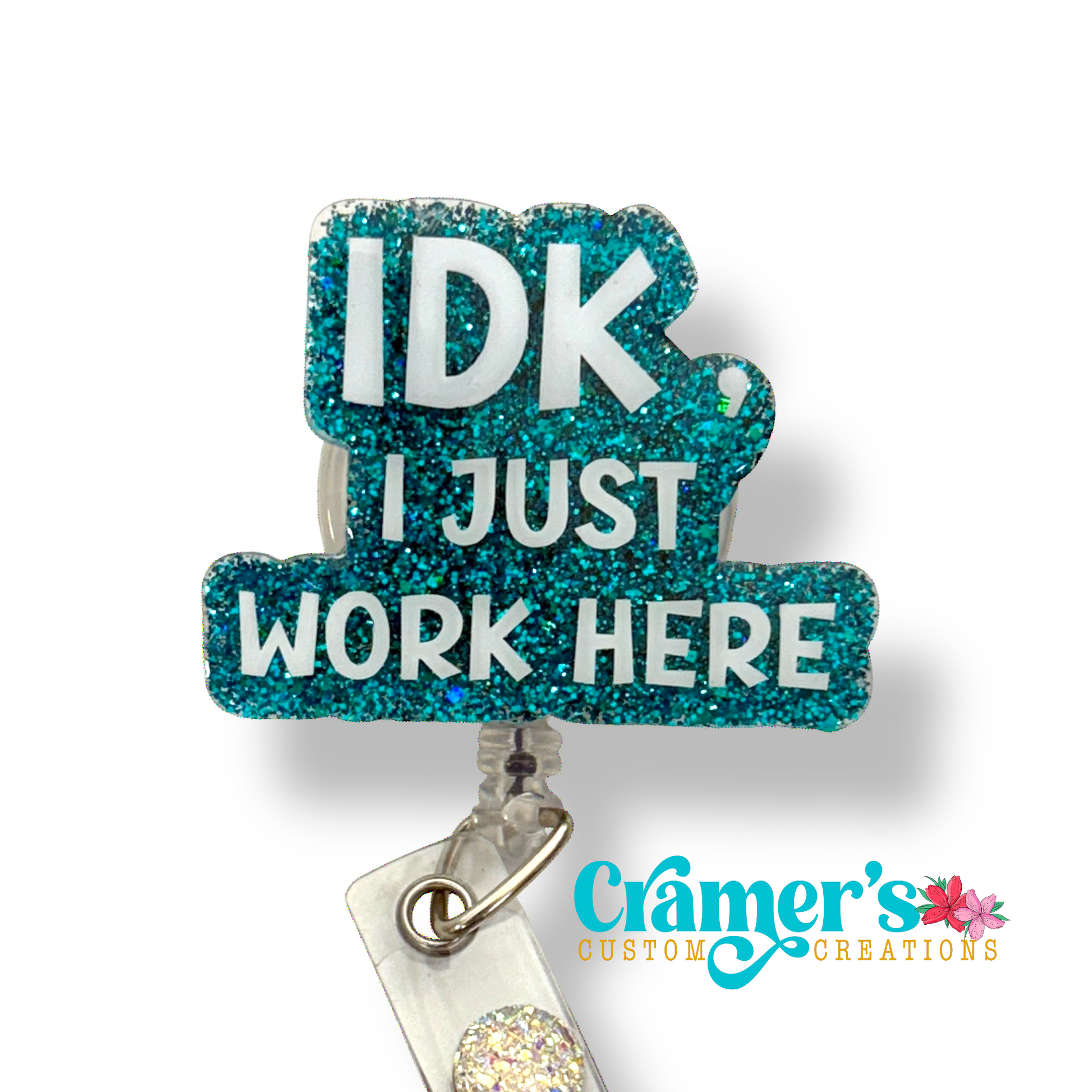 badge reel showing a teal glitter background with idk, i just work here in white