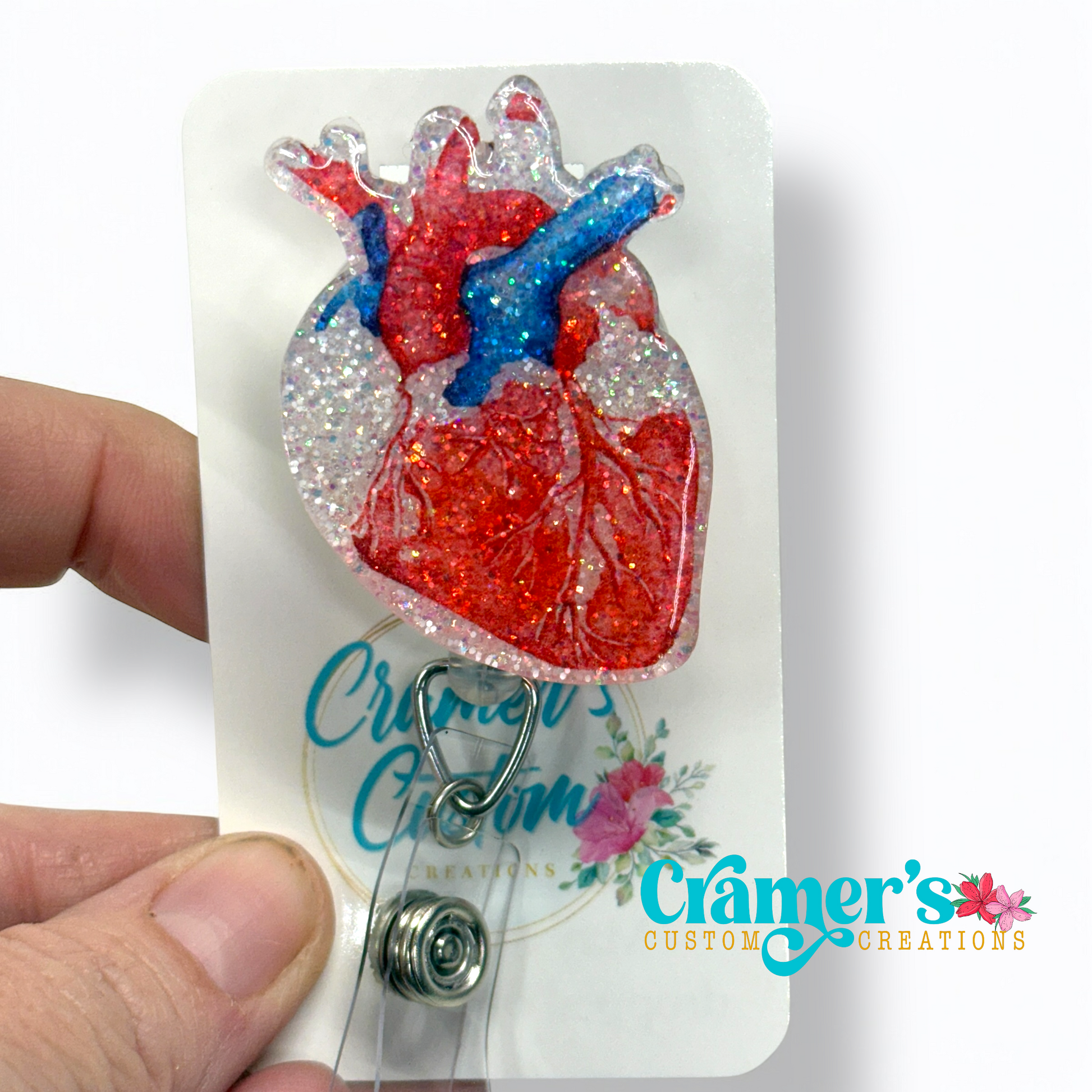 Realistic colored heart badge reel with a white glitter background