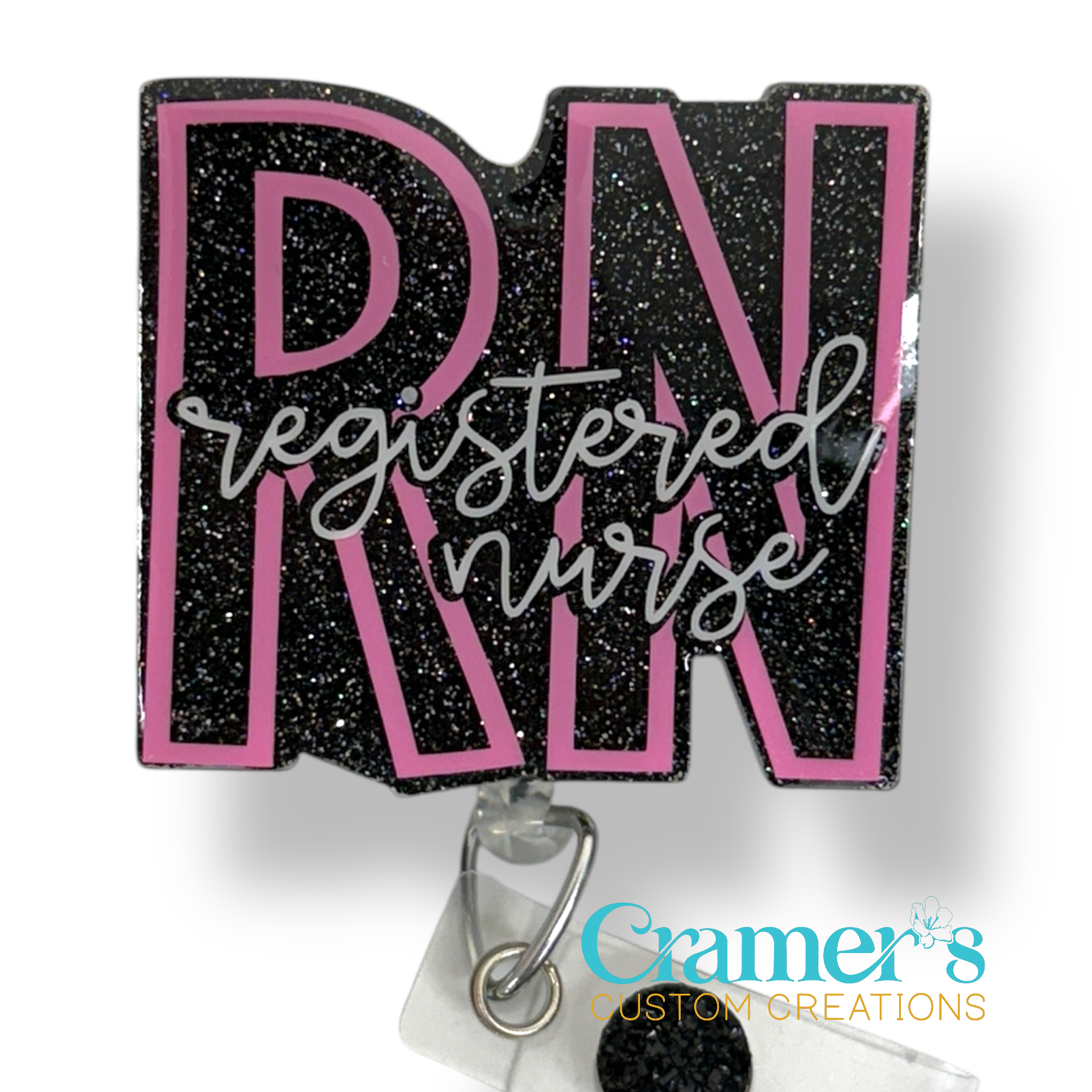 badge reel showing a black glitter background with the initials in pink and registered nurse in white 