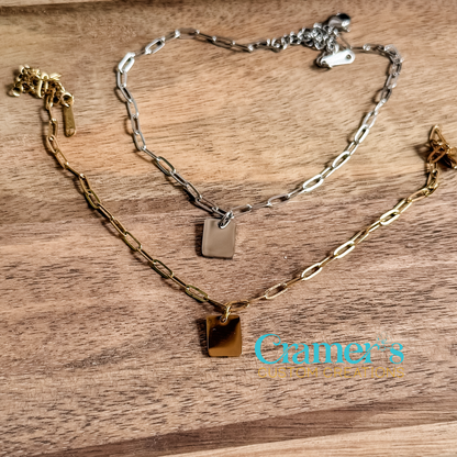 Two anklets on a wooden surface with 'Cramer's Custom Creations' branding.