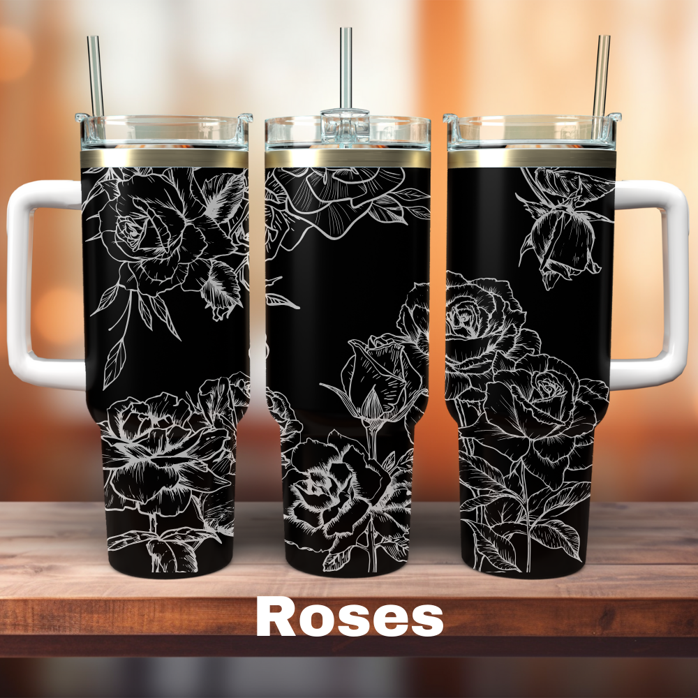 Two 40 oz tumblers with a floral design, predominantly featuring roses, in black color, placed on a wooden surface with the text 'ROSES' visible.