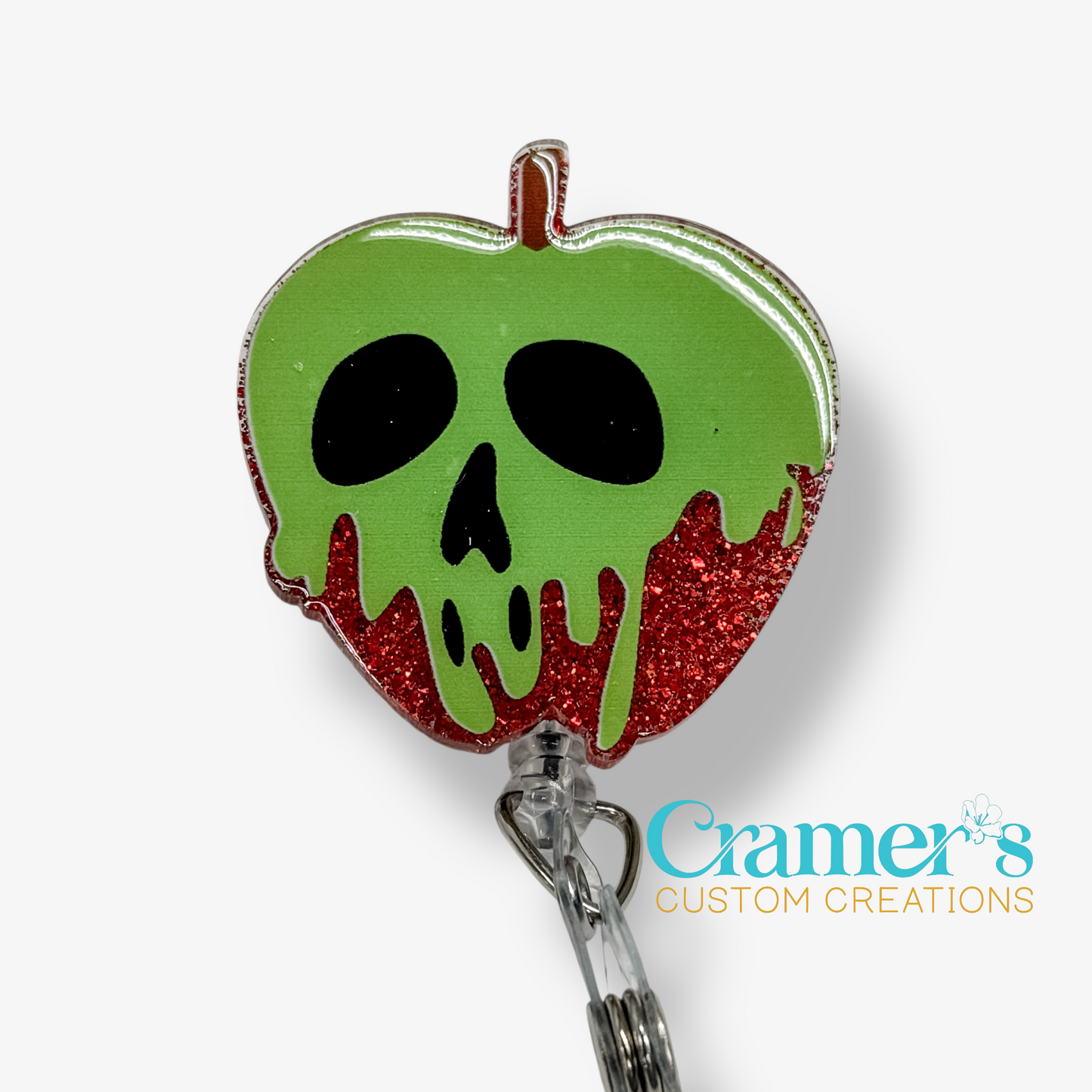 Green apple-shaped badge holder with skull design on a white background, featuring 'Cramer's Custom Creations' branding.