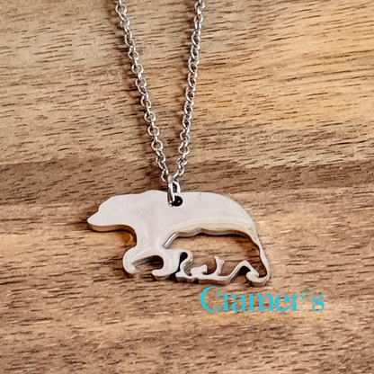 Silver necklace with a bear pendant on a wooden surface, featuring 'Gamer's Custom Creations' logo.