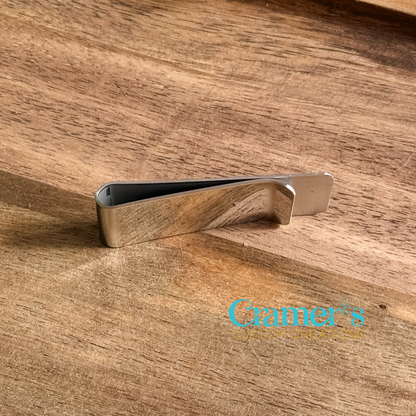 Silver money clip on a wooden surface with 'Cramer's Custom Creations' branding.