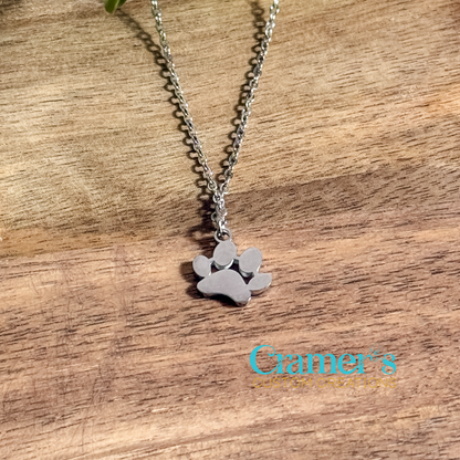 silver paw print necklace on a wood background