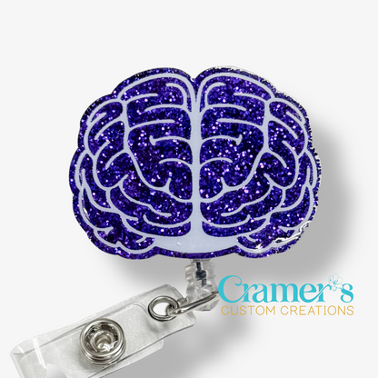 Purple glitter brain-shaped badge holder with a clear background