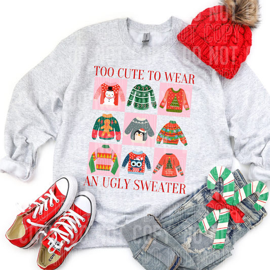 christmas flat lay with several ugly sweaters on a sweatshirt that says too cute to wear an ugly sweater