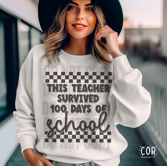 A woman wearing a white sweatshirt with text and a checkered pattern. The text reads 'This Teacher Survived 100 DAYS OF SCHOOL'.