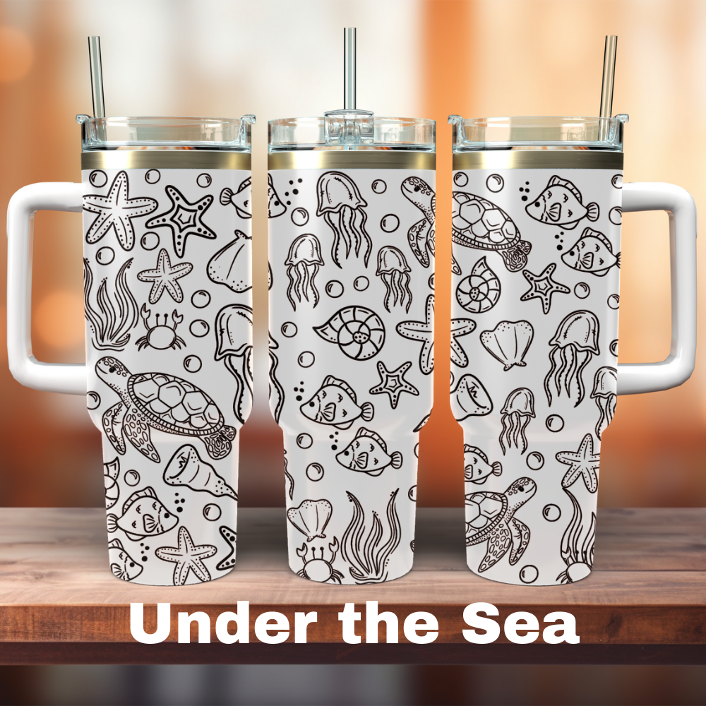 Three white 40 oz tumblers with laser engraved under the sea themed designs, including shells and sea life.