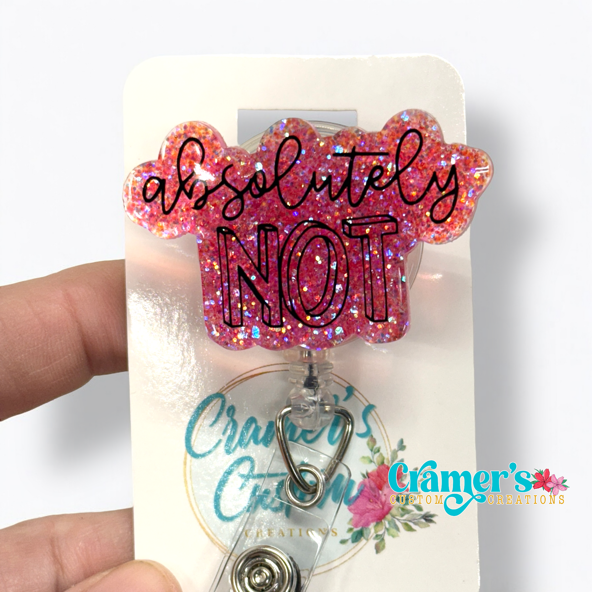 badge reel showing a pink glitter background with absolutely not in white