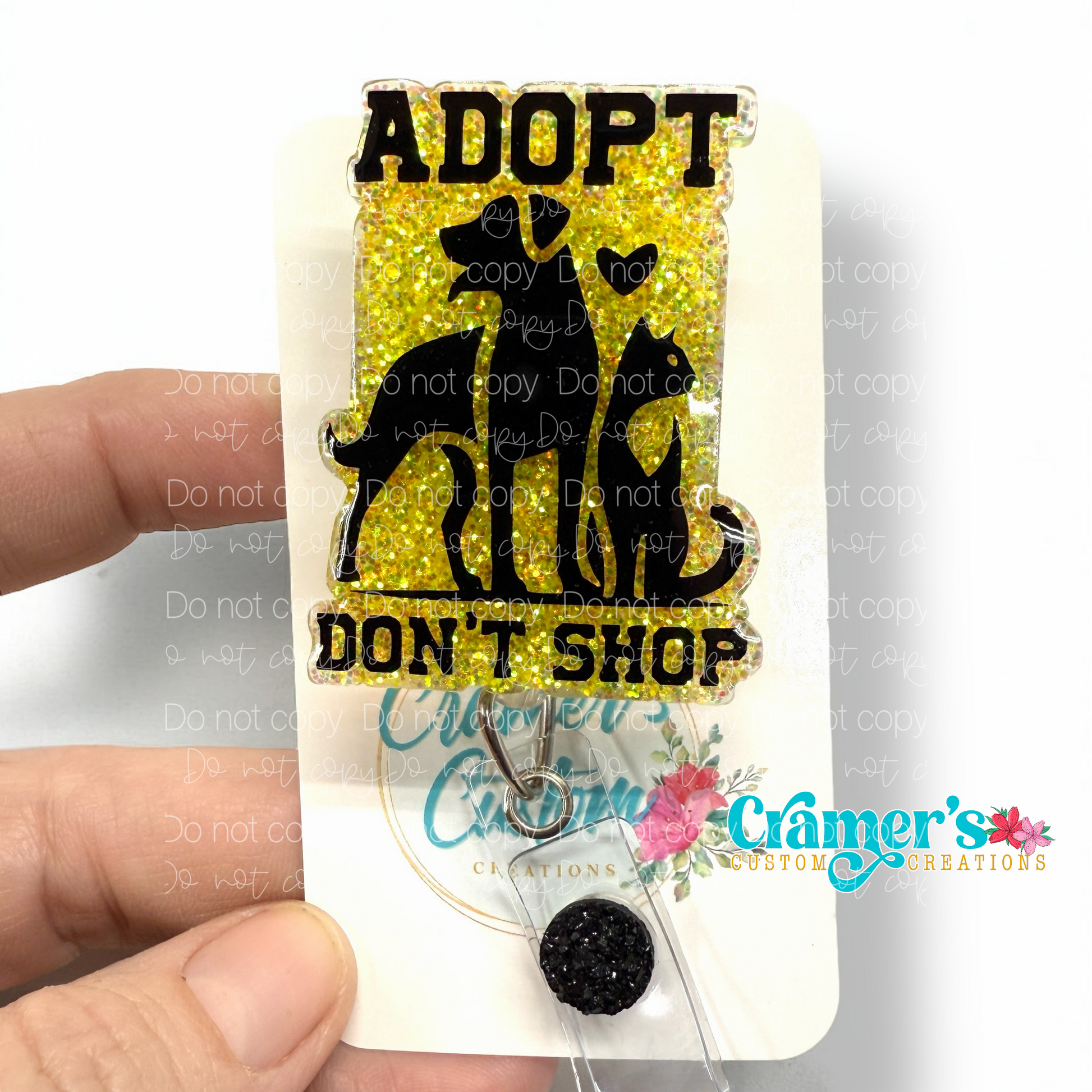 badge reel showing a yellow glitter background with adopt don't shop and a dog and a cat
