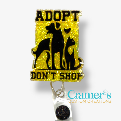 badge reel showing a yellow glitter background with adopt don't shop and a dog and a cat