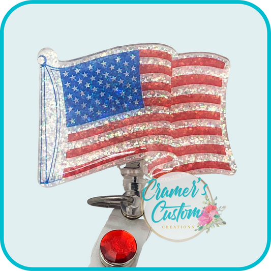glitter american flag badge reel on a light teal background