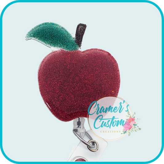 a glitter apple badge reel