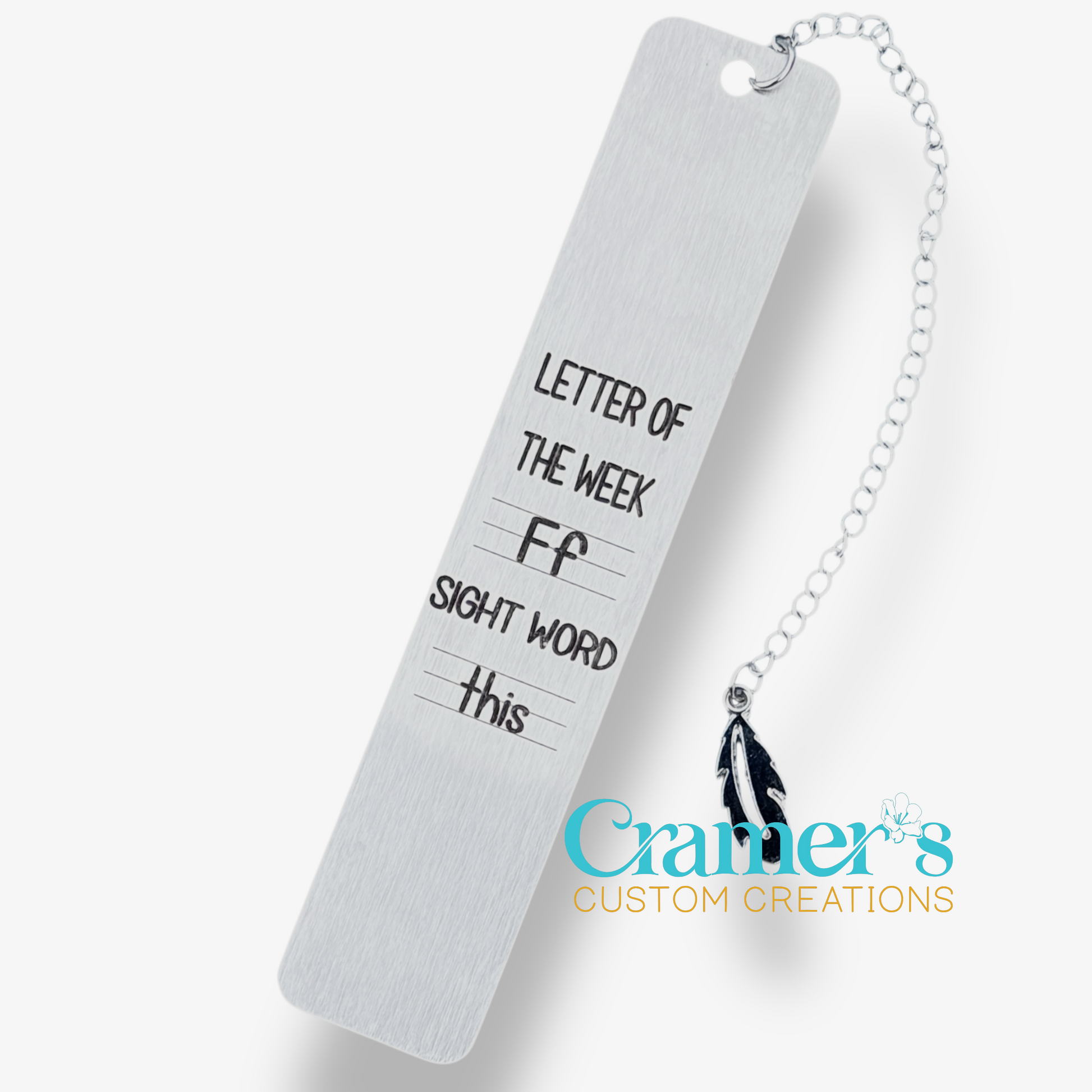 White bookmark with text and a chain, featuring Cramer's Custom Creations branding.